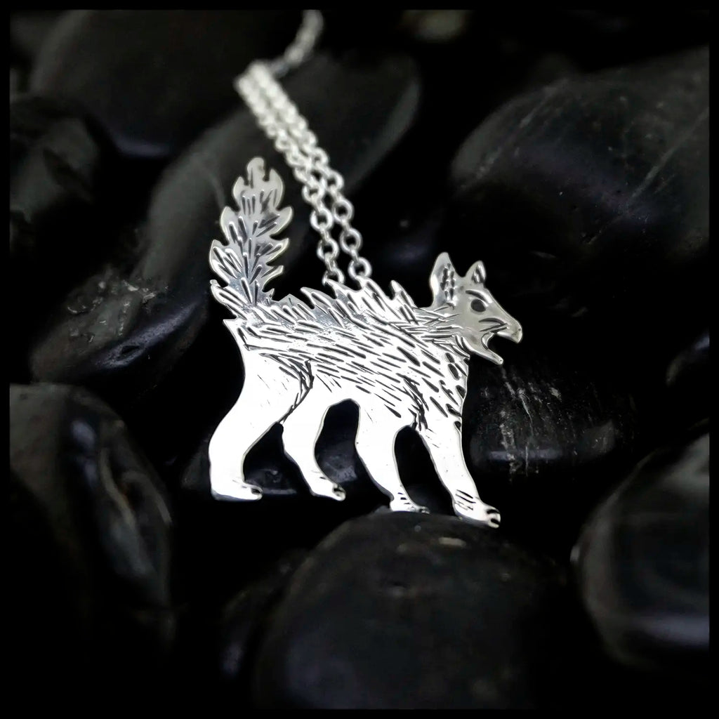 Silver Scaredy Cat pendant on a chain against a dark background