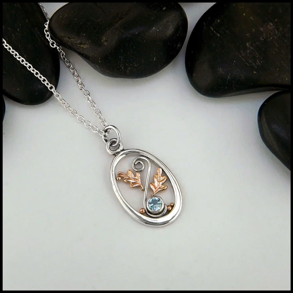 4mm Blue Topaz set in Sterling Silver  Pendant with 14K Rose Gold accents