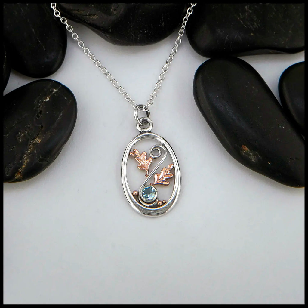 4mm Blue Topaz set in Sterling Silver  Pendant with 14K Rose Gold accents