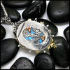 Moonstone pendant set with Blue Diamonds, Ruby, Tsavorites, and Blue Zircon in Sterling Silver and 14/18K Gold