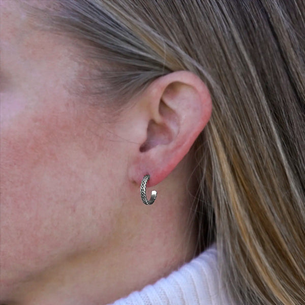Small Josephine's Knot hoop earring in sterling silver, worn on the ear