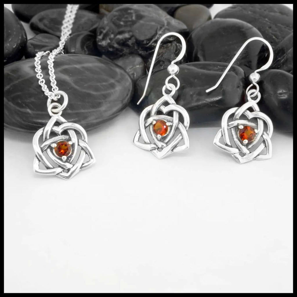 This lovely Limited Edition Set combines the Trinity Knot Heart drop earrings with its matching Pendant in Sterling Silver, both set with 4mm Deep Citrines. This set includes 18" Cable Chain.