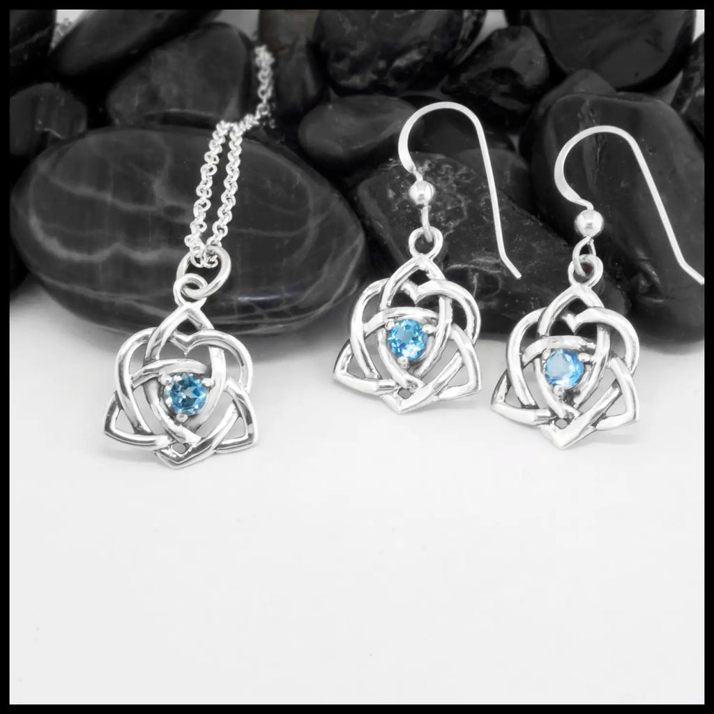Sterling Silver Trinity Heart Pendant and matching Earrings set with a 4mm Blue Topaz. Includes an 18" Cable Chain. This is a Limited Edition Set.