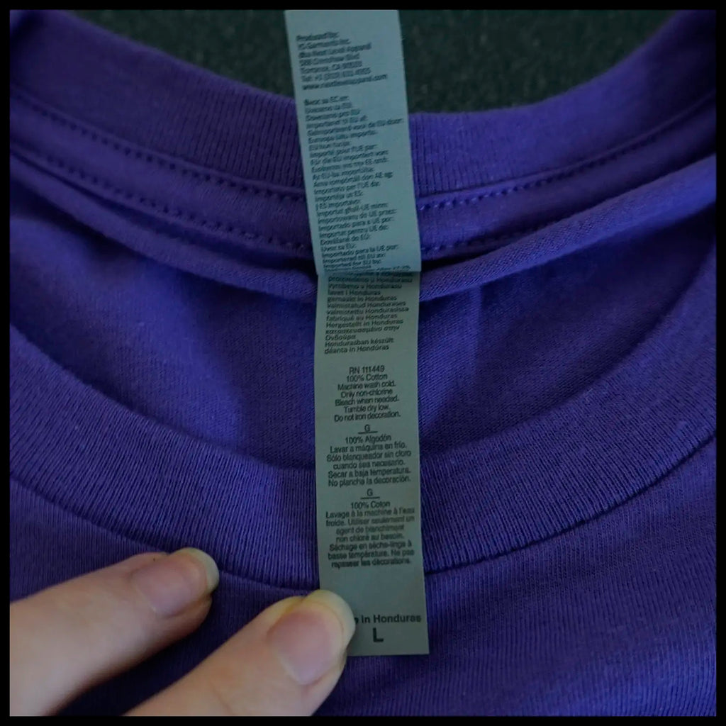 Close up of Washing/handling care instructions on t shirt. 100% Cotton