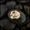 14K Yellow Gold ring with a detailed Scottish Thistle design on a dark stone surface