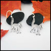 Silver Scaredy Cats earrings on a white background with autumn leaves.