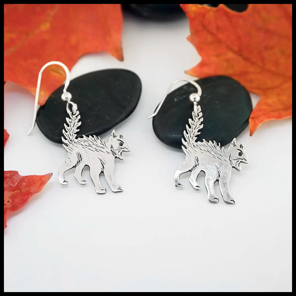 Silver Scaredy Cats earrings on a white background with autumn leaves.