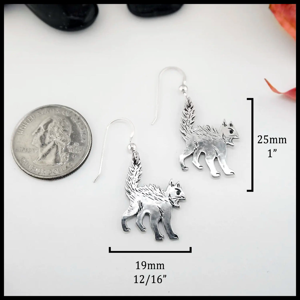 Silver cat-shaped earrings with measurements ( 25mm or 1" Tall and 19mm or 12/16") on a white background