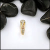Gold ring with gemstones on a white background with black stones around