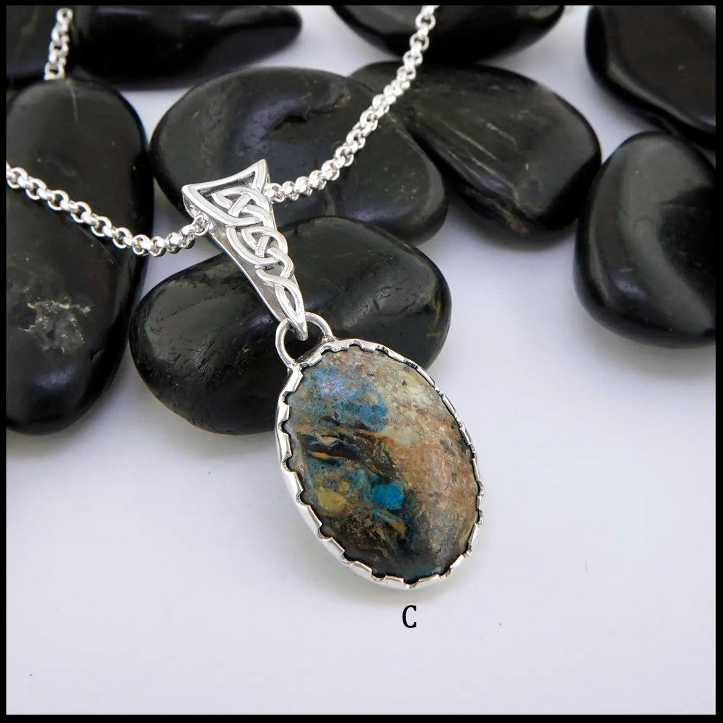 Silver pendant necklace with a stone pendant on a white background