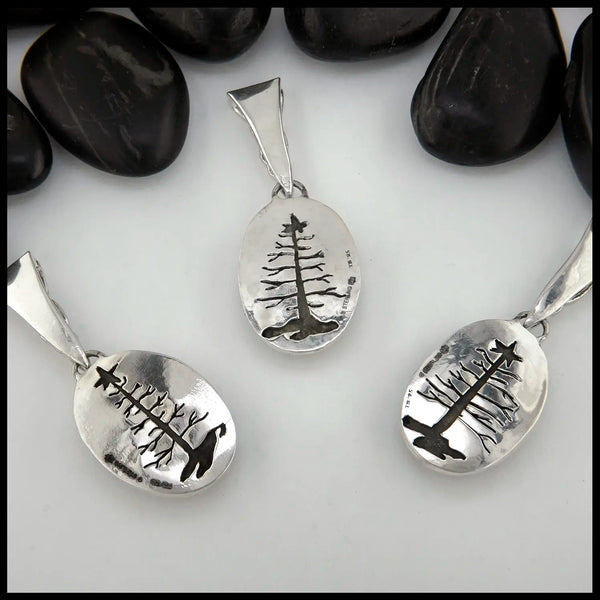 Sea Sediment Jasper with pine tree cut out on the back of the pendant in Sterling Silver