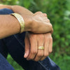 Trinity Knot Cuff Bracelet in gold, worn on the wrist