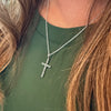 Trinity Scroll Cross Pendant in Sterling Silver worn on a chain