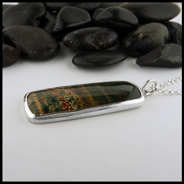 Profile view of bloodstone pine tree pendant