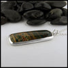 Profile view of bloodstone pine tree pendant