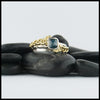 Custom 14K White Gold textured band with an 18K Yellow Gold cathedral design, set with a .59CT blue rose cut Diamond and a .06CT accent Diamond. 