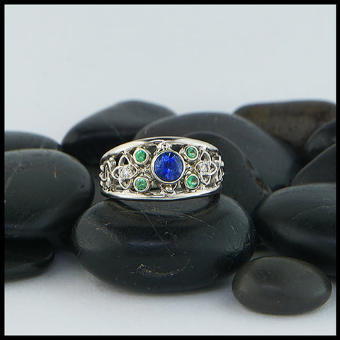 Custom Celtic Starlight ring has a 14K White Gold frame set with a 5.0mm Ceylon Sapphire, four 2mm Tsavorite Garnets, and two 1.5mm Diamonds.