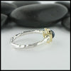 Profile view of rose cut green tourmaline ring in silver and gold