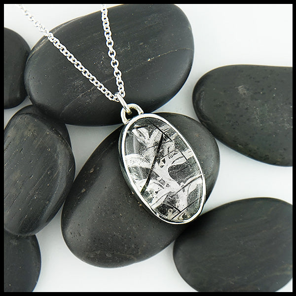 Custom hand-fabricated pendant in Sterling Silver with one of a kind Rutilated Quartz and hand-pierced vine design with 18K yellow gold details on the back.  Vine design visible through the stone.