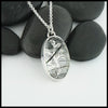 Custom hand-fabricated pendant in Sterling Silver with one of a kind Rutilated Quartz and hand-pierced vine design with 18K yellow gold details on the back.  Design is visible through the stone.