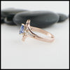 Profile view of custom 14K Rose Gold Celtic Trinity Knot ring, set with a genuine 7x5mm Blue Sapphire stone and two .04ct diamonds with 14K white gold details.