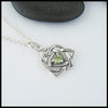 Limited Edition Trinity Knot Heart Pendant set with a 4mm Peridot.