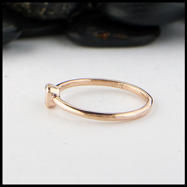 Profile view of simple 14K Rose Gold ring bezel set with a 0.09ct Emerald Cut Diamond.