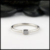 Simple 14K White Gold ring bezel set with a 0.09ct Emerald Cut Diamond.