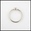 Profile view of simple 14K White Gold ring bezel set with a 0.09ct Emerald Cut Diamond.