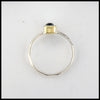 Profile view of rustic hand fabricated ring in sterling silver with an 18K yellow gold bezel set with a Rose Cut Blue Green Tourmaline.