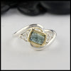 Rustic hand fabricated ring in sterling silver with an 18K yellow gold bezel, set with a Rose Cut  Green Tourmaline with trinity knot accents.