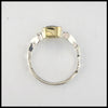 Profile view of rustic hand fabricated ring in sterling silver with an 18K yellow gold bezel, set with a Rose Cut Mint Green Tourmaline.