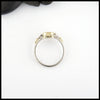 Profile view of Opal trinity ring with 0.54ct Black Opal and 14K White trinity accents and 18K Yellow Gold. 