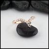 14K Rose gold chevron stacking band with ten 1.5mm diamonds with a 14K white gold trinity knot. 