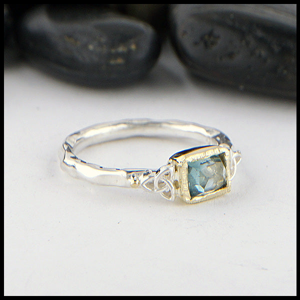 Sterling Silver and 18K yellow gold ring set with a Rose Cut Blue Tourmaline with trinity knot accents.