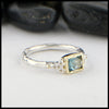 Sterling Silver and 18K yellow gold ring set with a Rose Cut Blue Tourmaline with trinity knot accents.