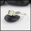 Sterling Silver and 18K yellow gold ring set with a Rose Cut Blue Tourmaline with trinity knot accents.