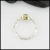 Profile view of Sterling Silver and 18K yellow gold ring set with a Rose Cut Blue Tourmaline with trinity knot accents.