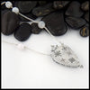 Reverse view of hand carved snowflakes on opal pendant